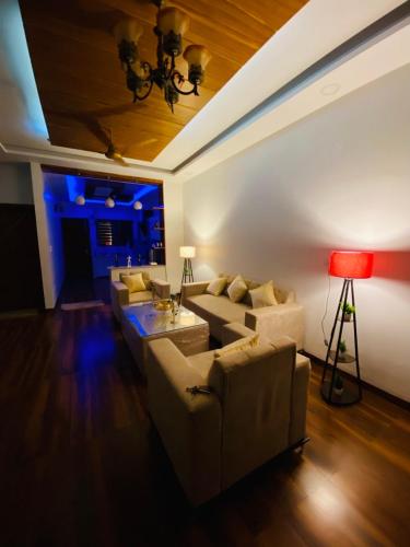a living room with two couches and a red lamp at 3BHK Stay Royal Villa in Mohali in Zirakpur