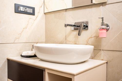 a white sink sitting on a counter in a bathroom at Evara Hills, Gangtok in Gangtok