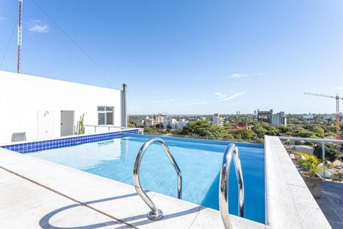 a swimming pool on the roof of a building at Apartamento de 1 Dormitorio con cochera - Dpto 507 in Asuncion