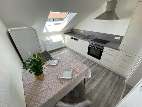a kitchen with a table with a plant on it at Haus Schwarzwald - Bad Krozingen in Bad Krozingen