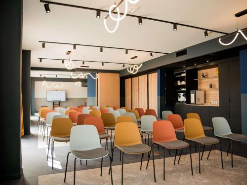 a room with rows of chairs and a podium at Tribe Carcassonne in Carcassonne