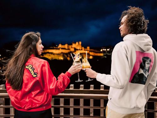 a man and a woman holding glasses of champagne at Tribe Carcassonne in Carcassonne