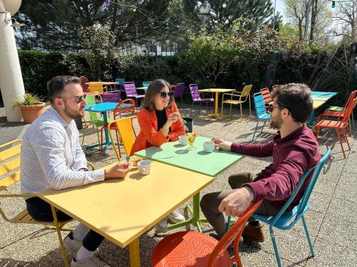 a group of three people sitting at a table at greet Hotel Bordeaux Aeroport in Mérignac