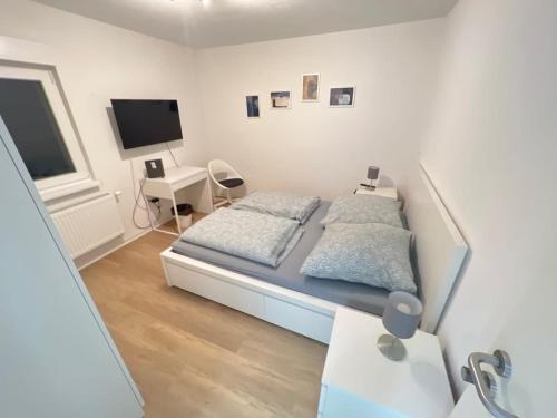 a bedroom with a bed and a desk and a tv at L8 Street - Mönsheim in Mönsheim