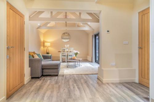 a living room with a couch and a table at White House Lodges - Tawny in Heveningham