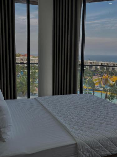 a bedroom with a bed with a view of a resort at SONA Hotel - Muine, Phan Thiet, Summerland in Ấp Chợ Dinh