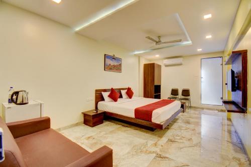 a hotel room with a bed and a tv at Classic Residency in Pune