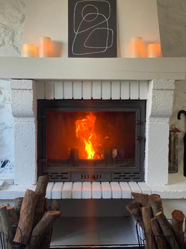 a fireplace with a fire in it at Alcarria , Casa del Agua in Albalate de Zorita