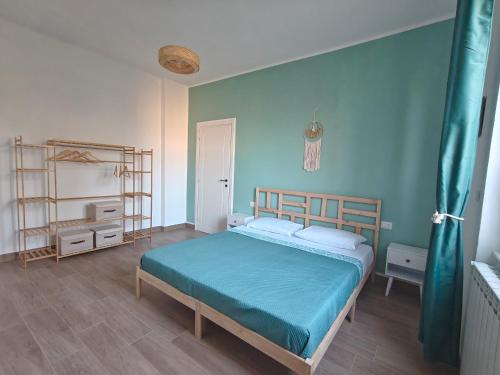 une chambre avec un lit et un mur bleu dans l'établissement Lakeside Montivivi Holiday home, à Cuasso Al Monte