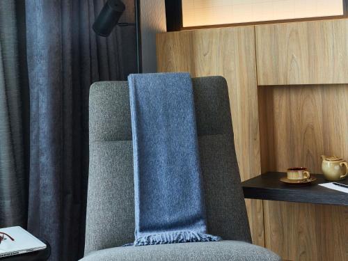 a chair with a blue towel on the back of it at Pullman Lima Miraflores in Lima