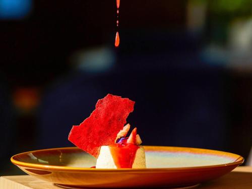 a piece of food on a plate on a table at Pullman Lima Miraflores in Lima