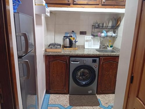 a kitchen with a washing machine in a kitchen at appartement de vacance Aourir2 in Aourir