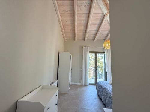 a room with a refrigerator and a bed in it at SeaForest Villa, Grand New! 2 km from Beach in Corfu