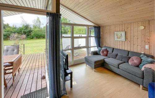 a living room with a couch and a table at 3 Bedroom Stunning Home In Rødby in Bjergemark