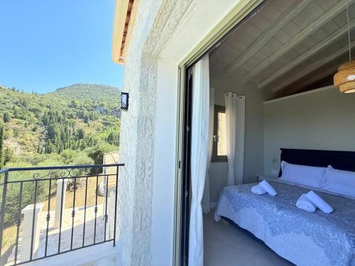 a bedroom with a bed and a balcony with a view at SeaForest Villa, Grand New! 2 km from Beach in Corfu