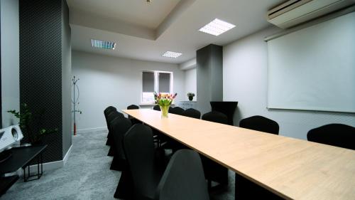 a conference room with a long table and chairs at Nova Hotel in Radom