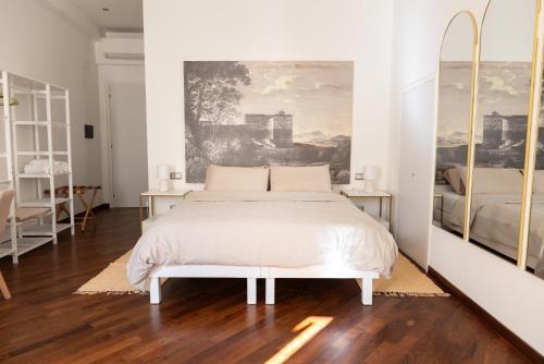 a bedroom with a bed and a painting on the wall at Ferentino B&B in Ferentino