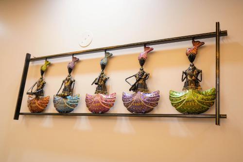 a group of vases on a shelf on a wall at Lime Tree Two BHK Service Apartment Golf Course Road Gurgaon in Gurgaon