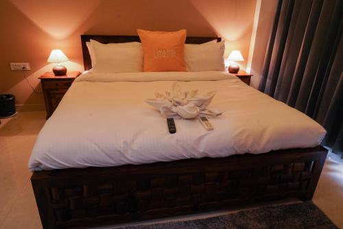a bedroom with a bed with a flower on it at Lime Tree Two BHK Service Apartment Golf Course Road Gurgaon in Gurgaon