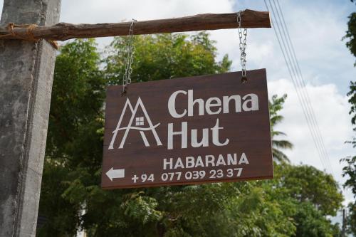a sign for a chinese restaurant hanging from a pole at Chena Hut Habarana in Habarana