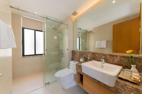 a bathroom with a sink and a toilet and a shower at Green Garden villa in Cam Lâm