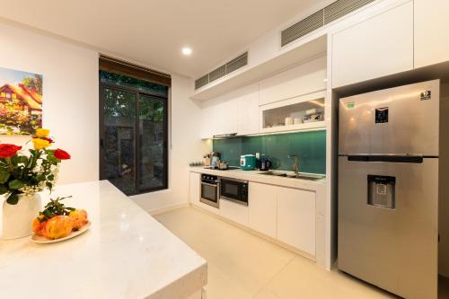 a kitchen with a counter top and a refrigerator at Green Garden villa in Cam Lâm