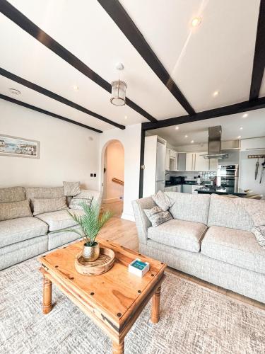a living room with two couches and a coffee table at Sea Anchor Saundersfoot in Saundersfoot