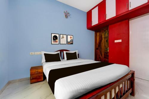 a bedroom with a large bed with a red headboard at Collection O Balaramapuram White Castle in Kovalam