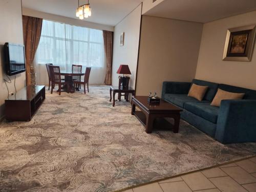a living room with a couch and a table at Sadeem Al Fajr Hotel Suites in Taif