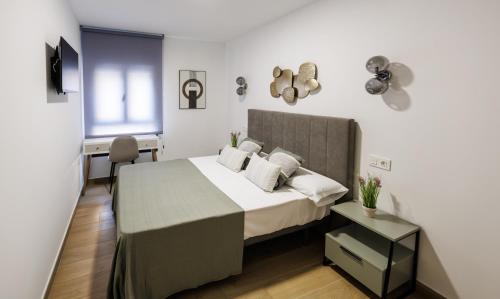 Ένα ή περισσότερα κρεβάτια σε δωμάτιο στο Marwan Apartamentos Turísticos