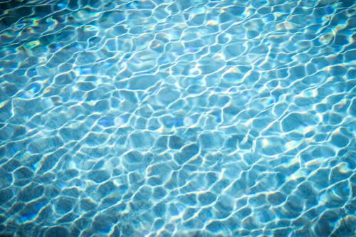 a close up of water in a swimming pool at goldfinger + suites in Lana