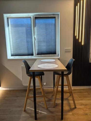a table and two chairs in front of a window at Atractiv Two Luxury in Dudu