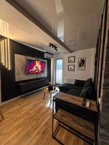 a living room with a couch and a fireplace at Atractiv Two Luxury in Dudu