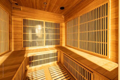 an empty sauna with wooden walls and wooden floors at Campagne et bien être - Collection Idylliq in Villiers-sous-Grez