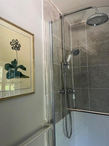a bathroom with a shower with a glass door at Weston Hill Farm in Moreton Pinkney