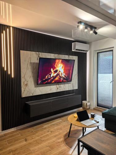 a living room with a fireplace with a tv at Atractiv Two Luxury in Dudu