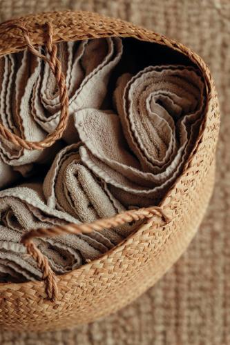 a wicker basket filled with towels on a table at Villa Gerês Emblematico - Piscina & Jacuzzi in Venda Nova