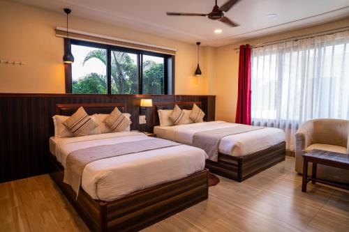 Letto o letti in una camera di Royal Resort, itahari