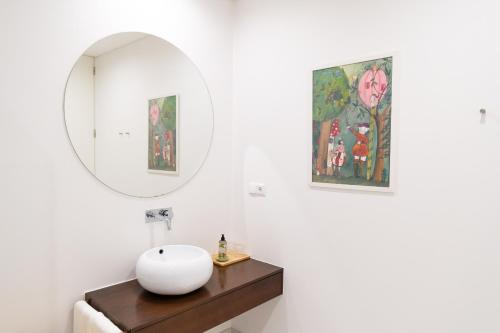 a bathroom with a white sink and a mirror at NEW!! Lugar das Letras in Sabrosa