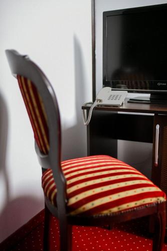 a desk with a chair with a computer monitor at Hotel Zodiak in Radomsko