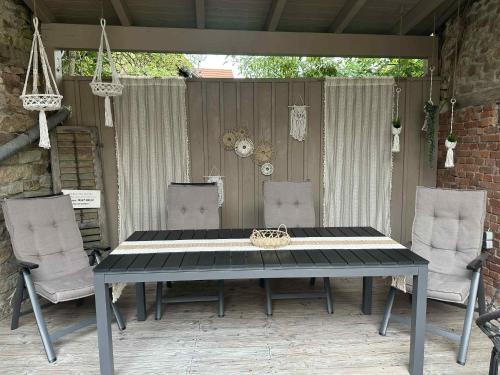 a table and chairs sitting on a patio at Altes Grabenhöfchen - 5 Sterne Ferienhaus in Stetten