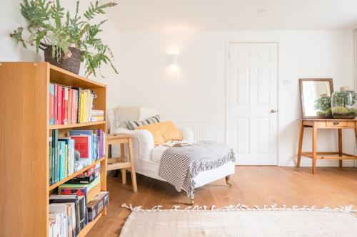 a living room with a couch and a book shelf at The Bantams, Monk Soham in Bedfield