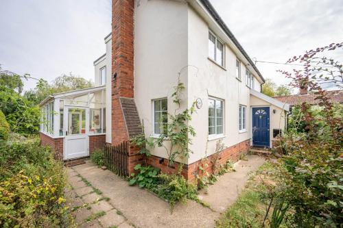 an old brick house with a blue door at The Bantams, Monk Soham in Bedfield