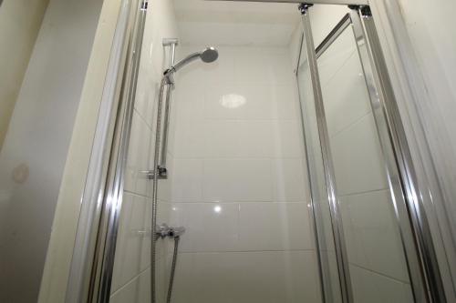a shower with a glass door in a bathroom at Reeves House By Smart Corporate Stays in Derby
