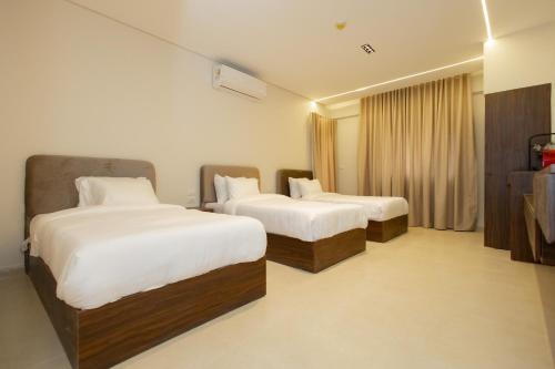 a hotel room with two beds and a window at Imperial Luxury Hotel in Cairo
