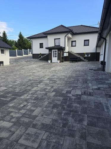 a large patio in front of two buildings at Napoli sobe in Sveti Ivan Žabno