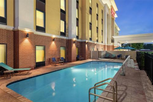 a swimming pool in front of a hotel at Hampton Inn & Suites by Hilton Tampa Busch Gardens Area in Tampa