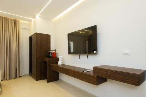 a living room with a tv on a wall at Imperial Luxury Hotel in Cairo
