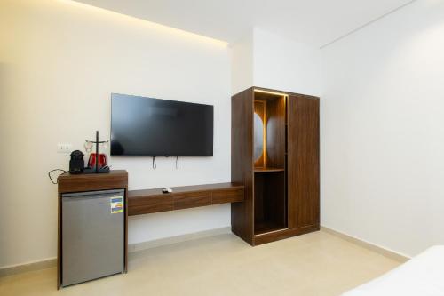 a room with a flat screen tv on a wall at Imperial Luxury Hotel in Cairo