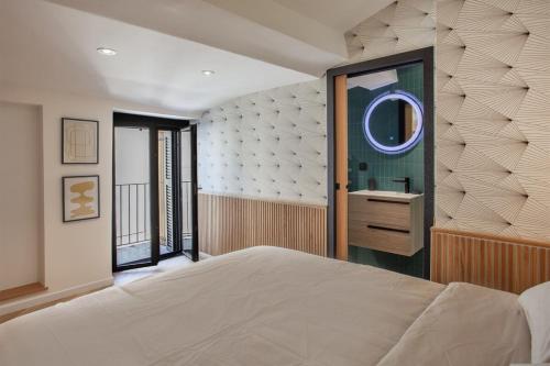 a bedroom with a large bed and a mirror at Casa Miot in Bastia